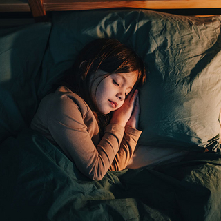 Kind schläft im Bett